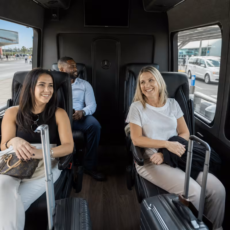 Passengers loading luggage while boarding an Las Vegas group shuttle