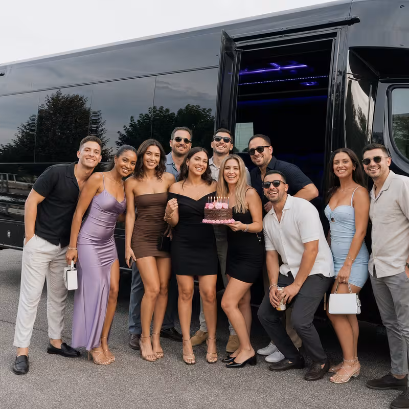 Group boarding a white charter bus for Birthday Transportation transportation in Las Vegas