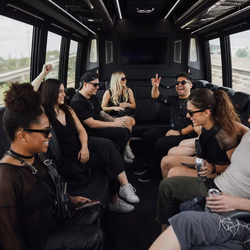 Group boarding a white charter bus for Concert Transportation transportation in Las Vegas