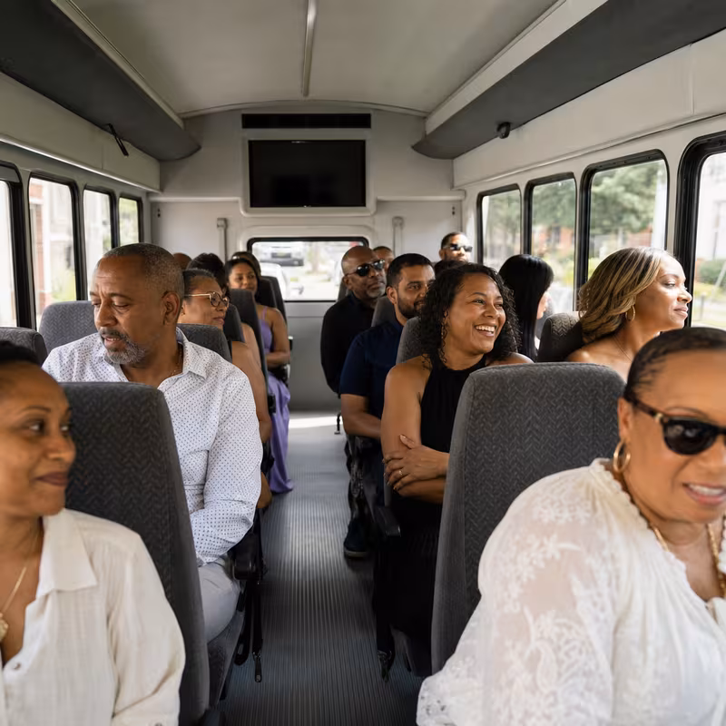 Group boarding a white charter bus for Private Event Transportation transportation in Las Vegas