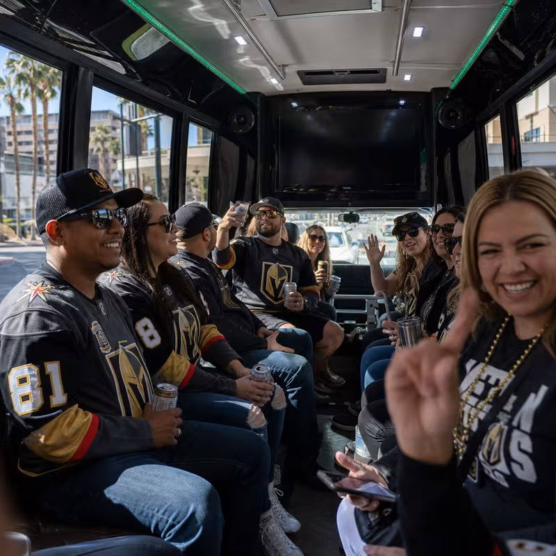 Group boarding a white charter bus for Sporting Event Transportation transportation in Las Vegas