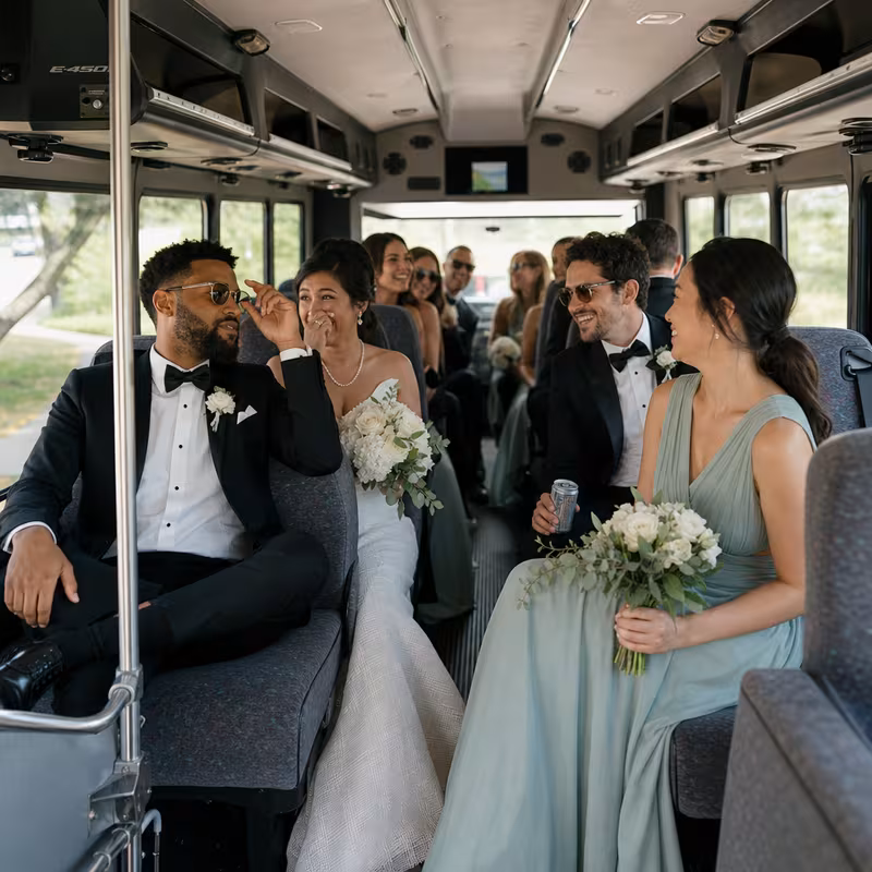 Group boarding a white charter bus for Wedding Transportation transportation in Las Vegas